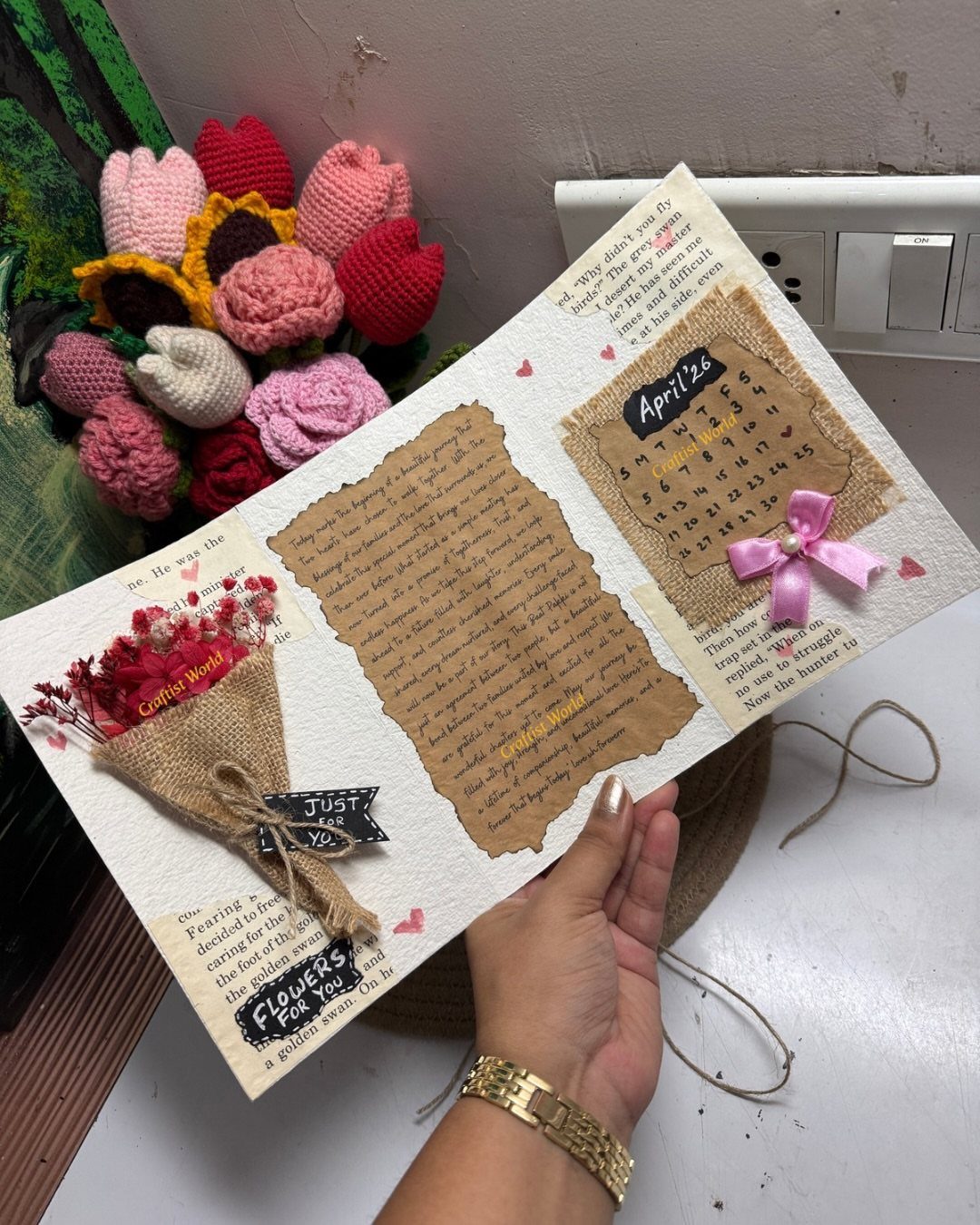 Open scrapbook page with a handwritten letter, calendar, and small dried flower bouquet.