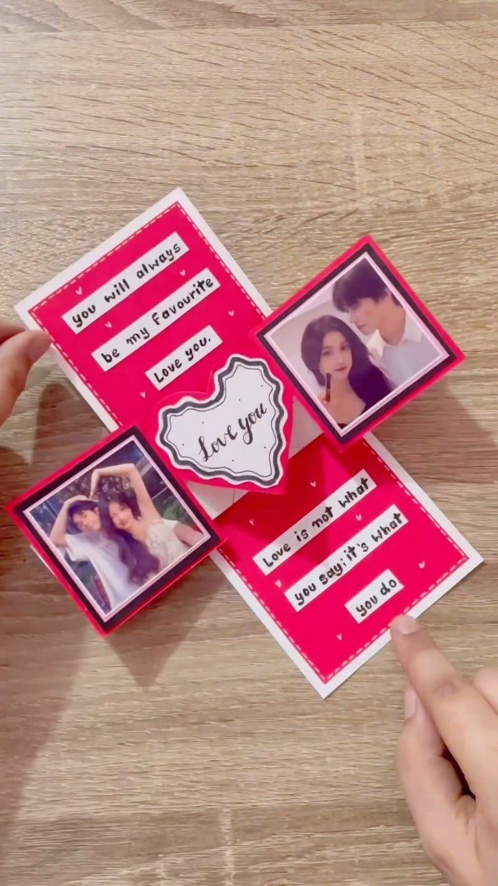32 Anniversary Card Ideas to Make at Home (Photos Inside) 21 Handmade red anniversary card with couple photos and romantic quotes on wooden background