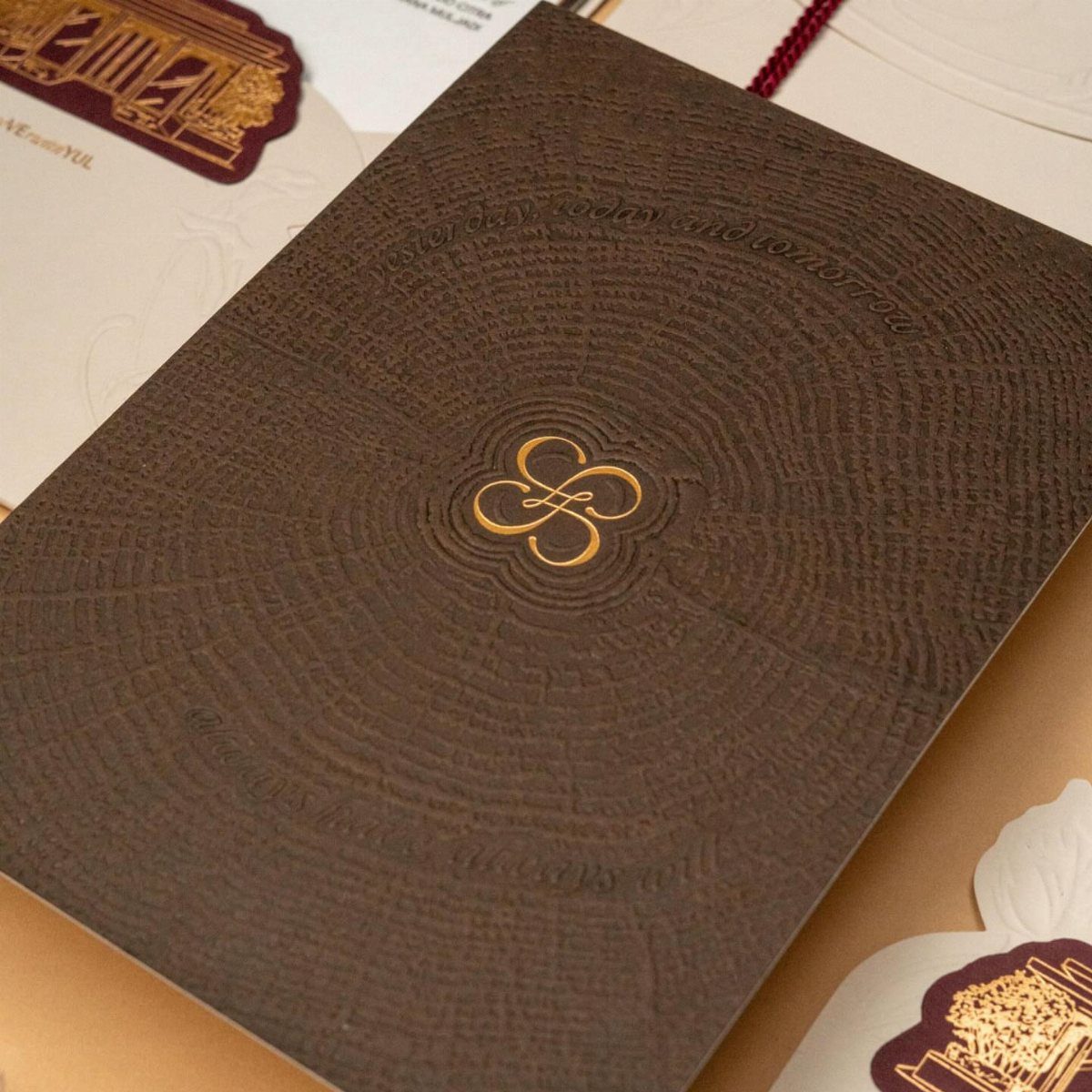 32 Anniversary Card Ideas to Make at Home (Photos Inside) 33 Brown textured anniversary card with a gold foil knot symbol in the center.