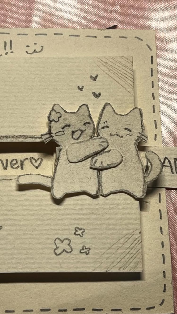 32 Anniversary Card Ideas to Make at Home (Photos Inside) 27 Handmade brown kraft paper card featuring two cute grey cats hugging with small hearts.