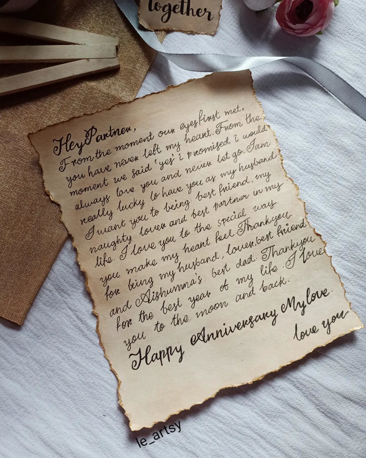 32 Anniversary Card Ideas to Make at Home (Photos Inside) 6 Handwritten love letter on aged parchment paper with burnt edges and a pink rose.