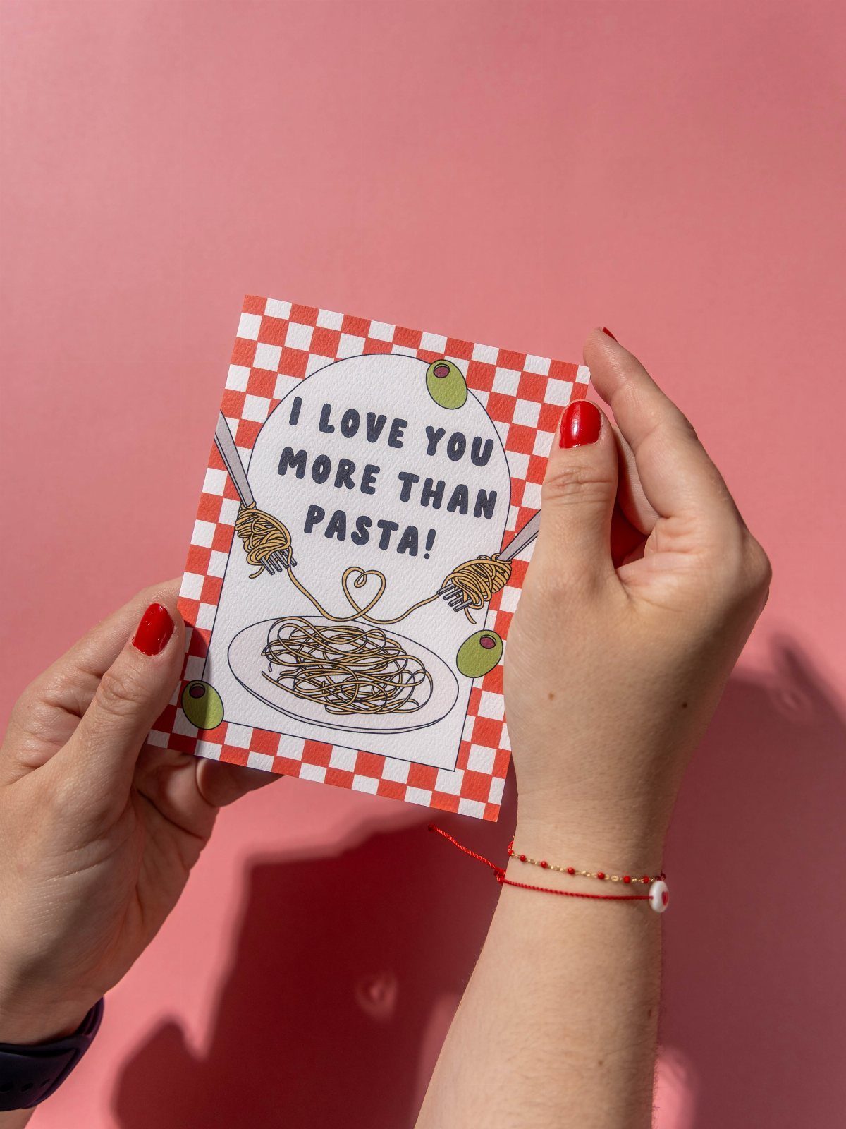32 Anniversary Card Ideas to Make at Home (Photos Inside) 23 Greeting card with pasta illustration and text held against a pink background
