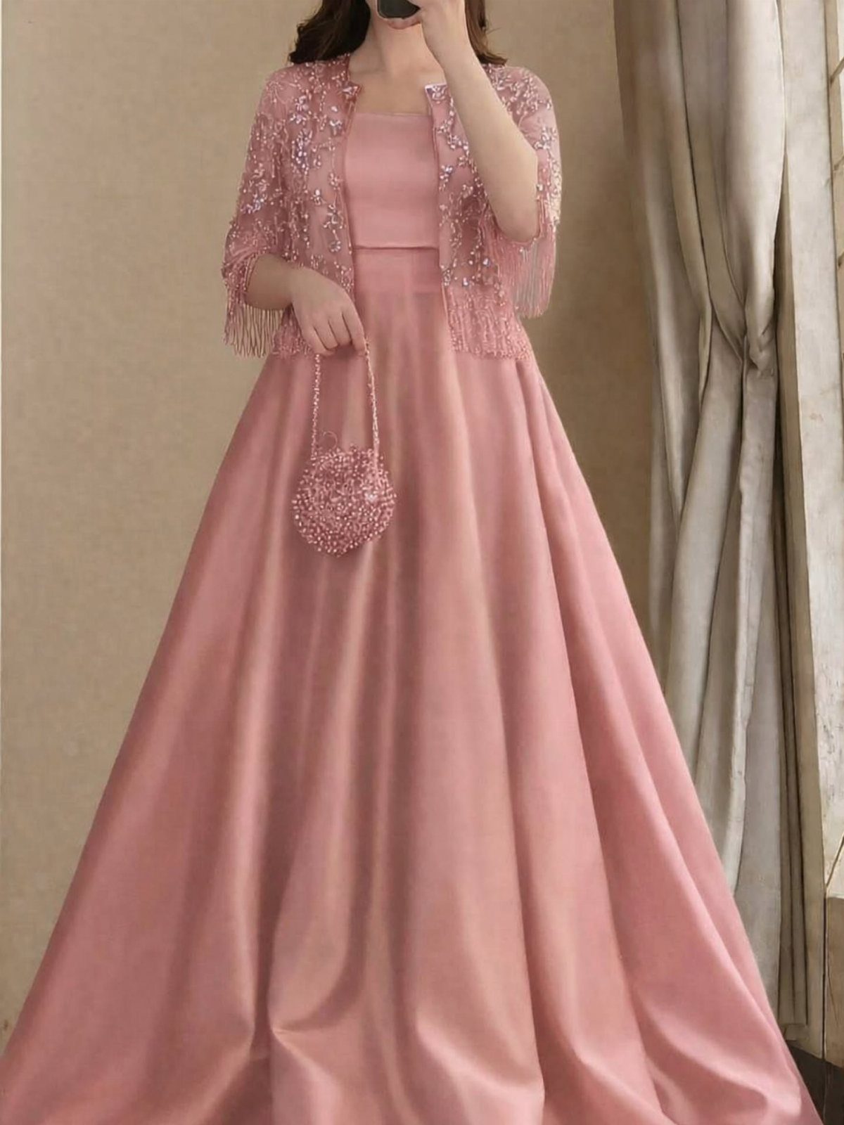 Pink satin floor-length gown with a matching embellished lace bolero and beaded handbag.