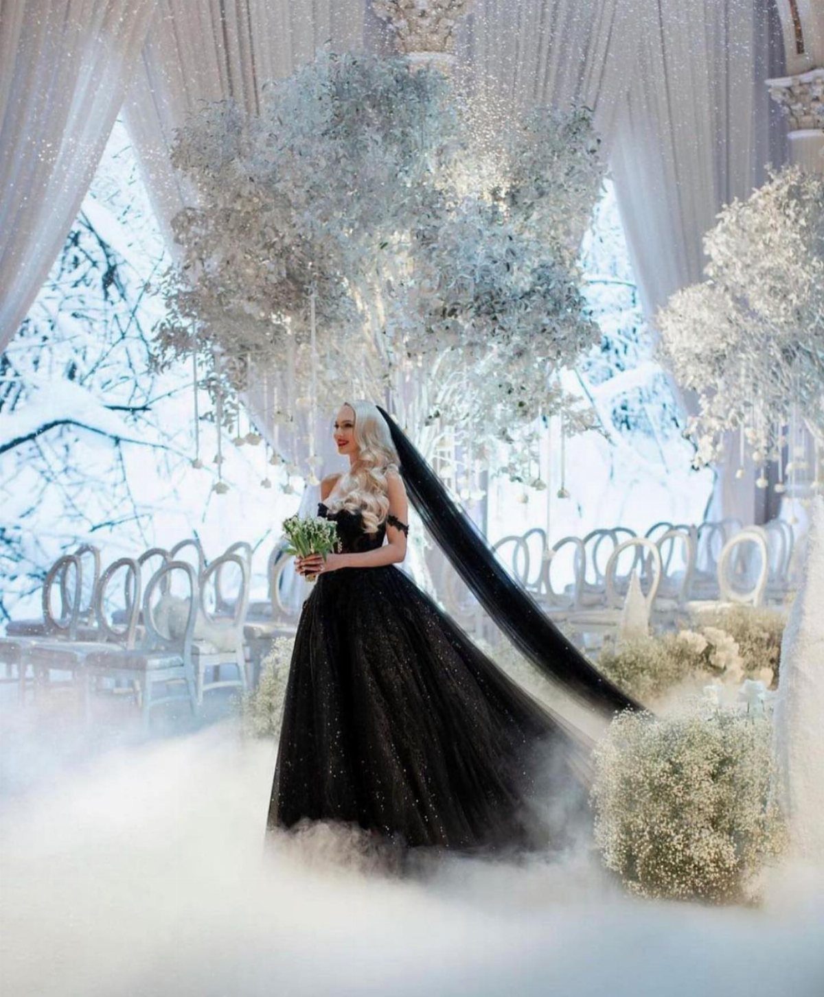Claire Wedding Dress Styles: 11 Gowns to Inspire Your Look 8 Woman in a sparkling black wedding gown and veil in a wintery setting.