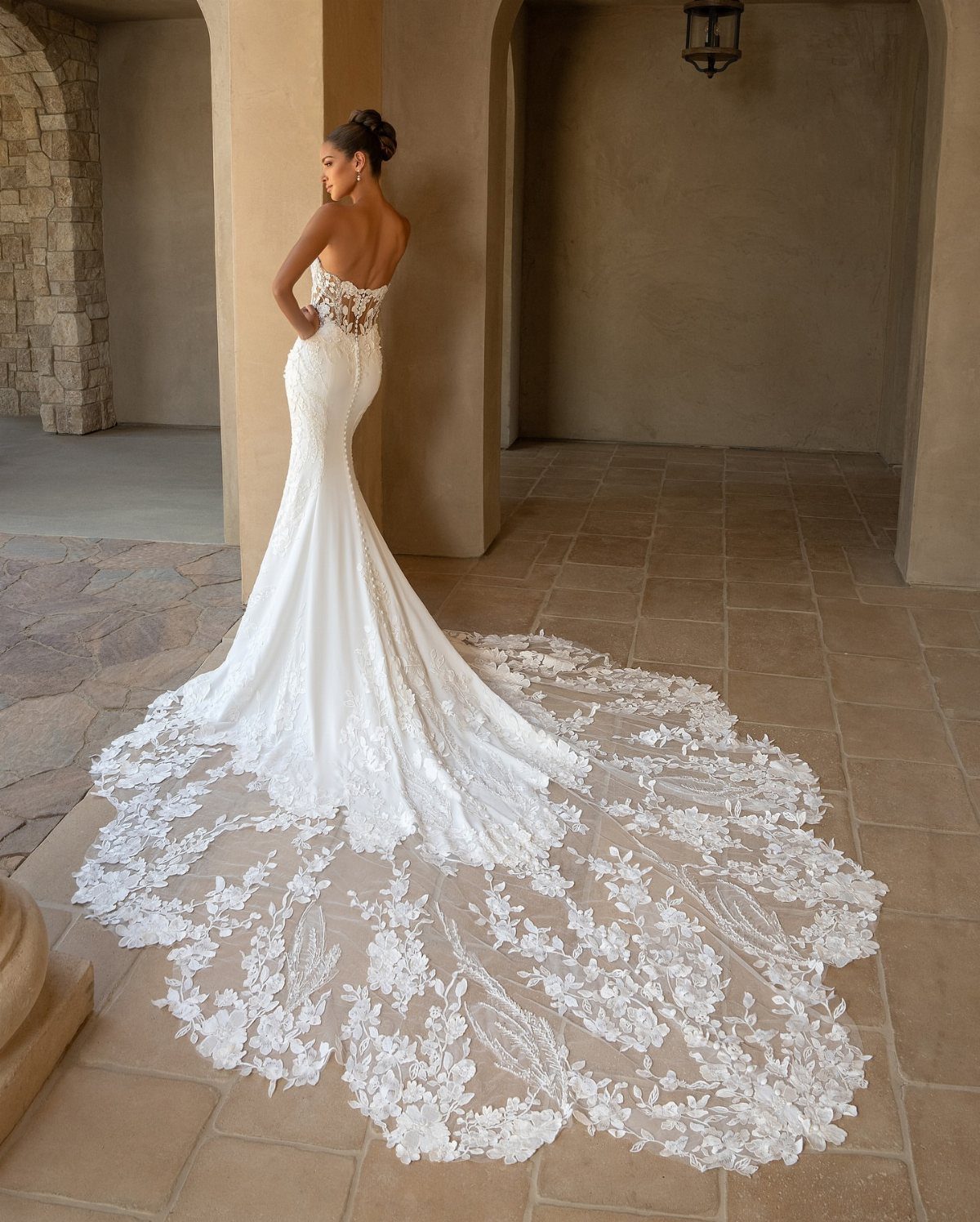 Claire Wedding Dress Styles: 11 Gowns to Inspire Your Look 3 Woman in a white strapless mermaid wedding gown with a long embroidered lace train.
