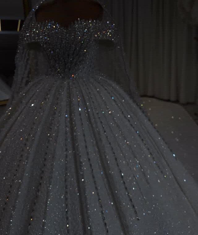Sparkling white ball gown wedding dress with a glittery bodice and full shimmering skirt