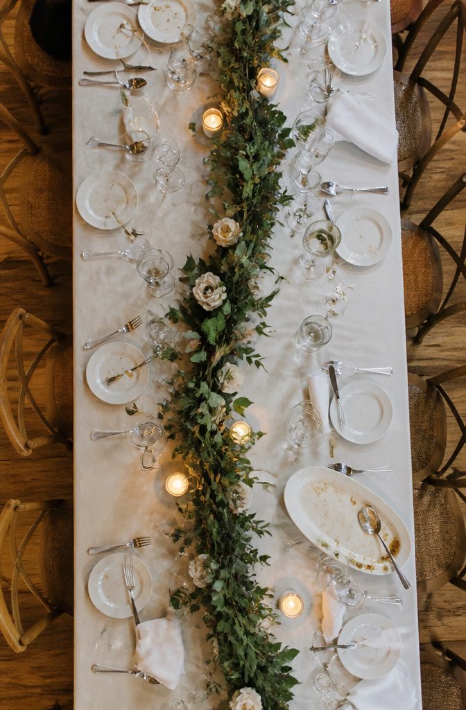 Banquet table lined with eucalyptus smilax and Italian ruscus greenery
