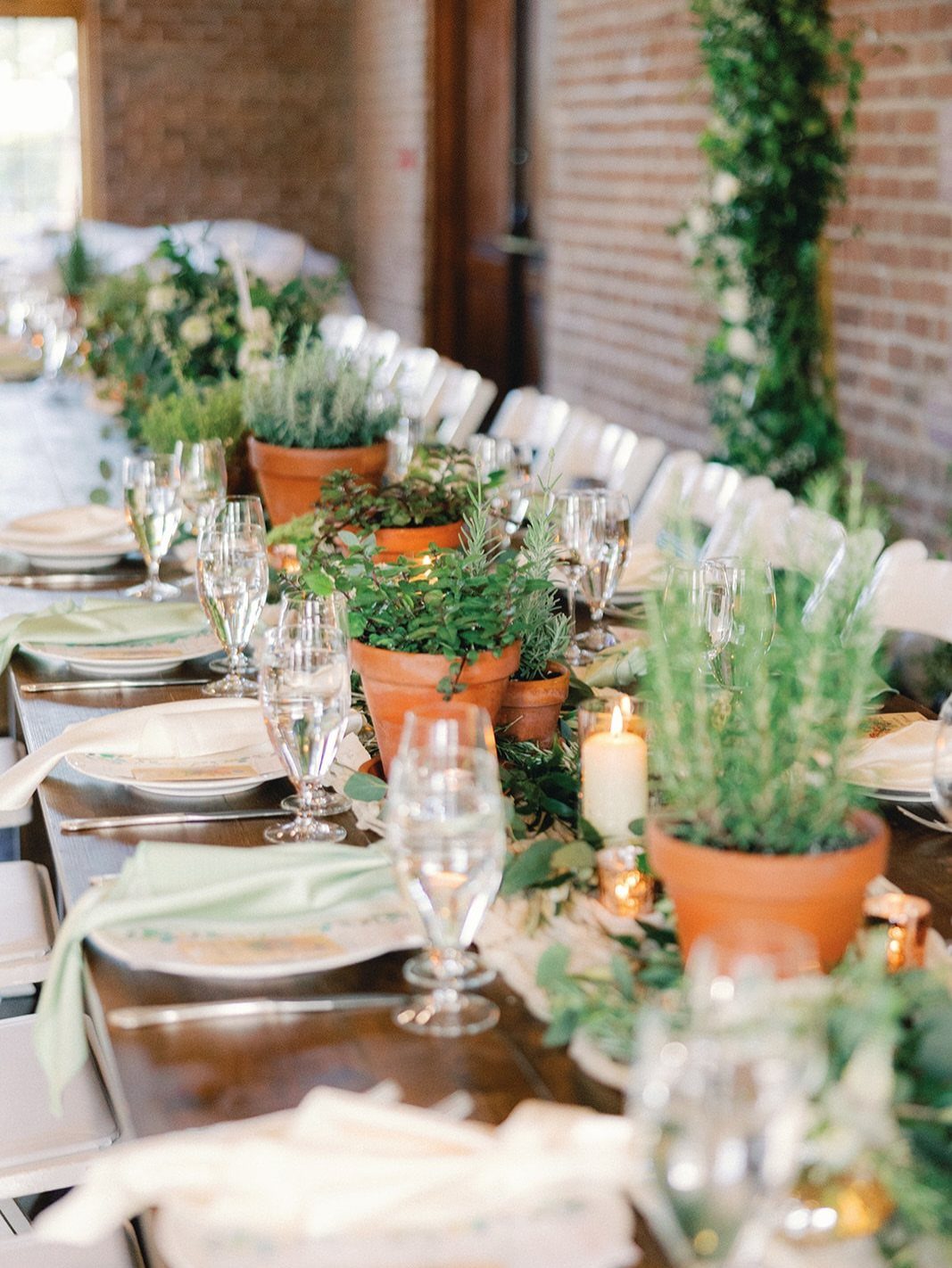 Green Bridal Shower Ideas: 10 Eco-Friendly Party Picks 2 Terracotta pots with green herbs as centerpieces on a wooden dining table.