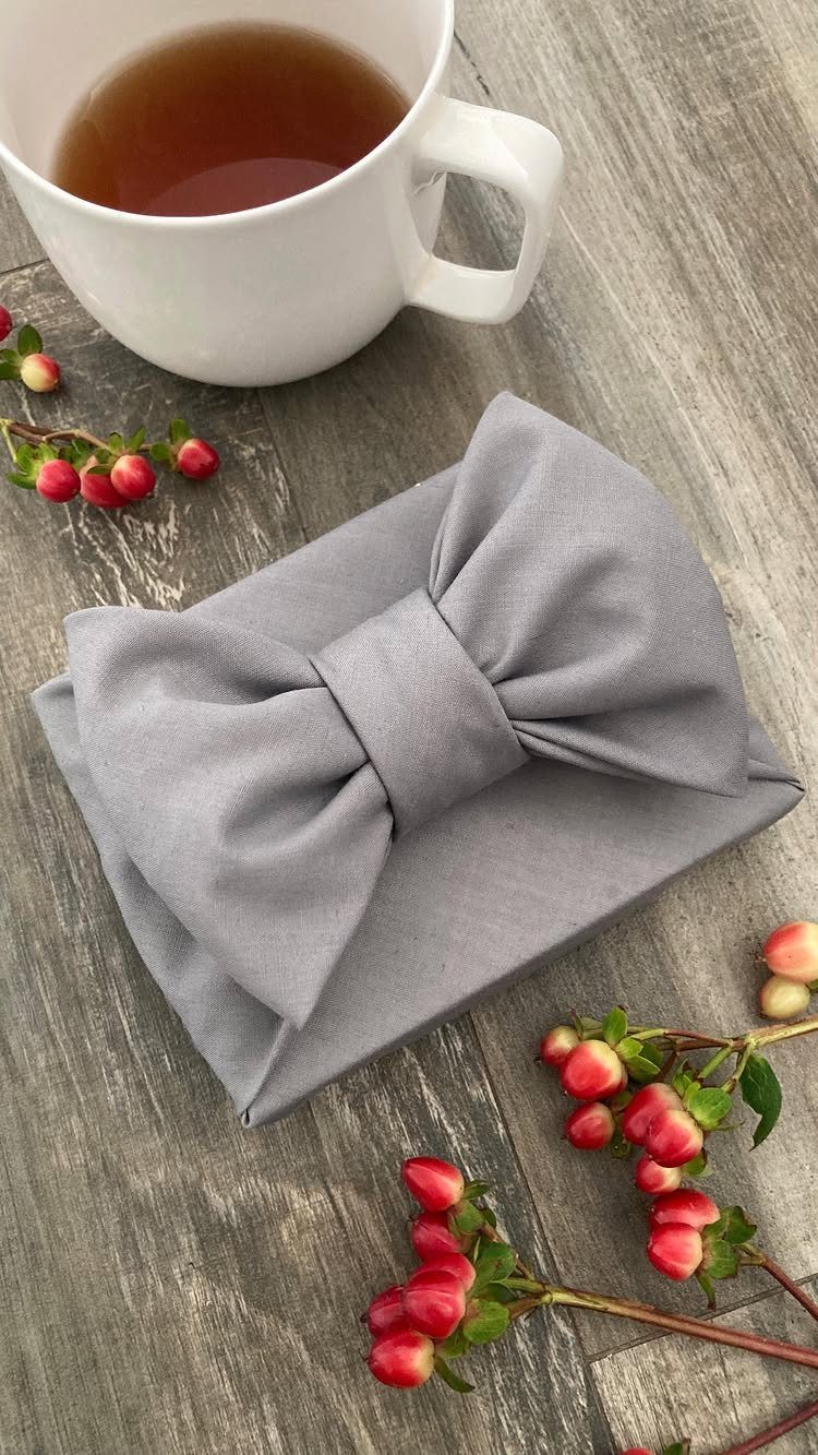 Green Bridal Shower Ideas: 10 Eco-Friendly Party Picks 9 Grey fabric gift wrap tied in a bow next to tea and berries