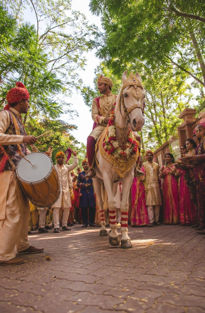 A groom leading a lively baraat with family and friends celebrating.