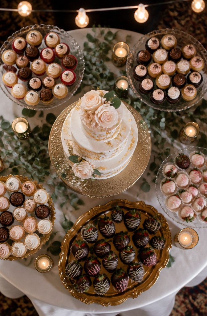 Wedding cake is served with small cups of ice cream on the dessert table.