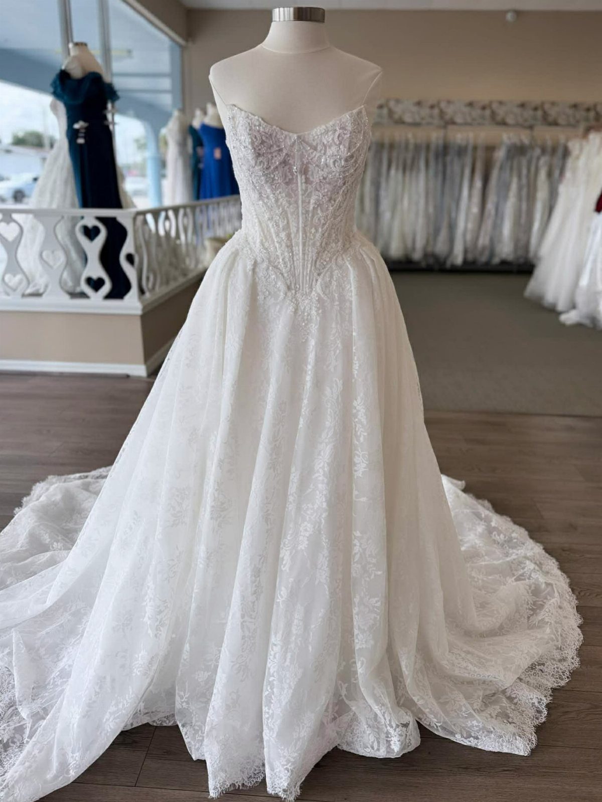 White lace wedding dress with a strapless corset bodice and full A-line skirt.
