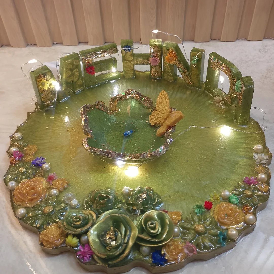 Green resin mehndi platter with 3D lettering, gold glitter, and floral decorations.