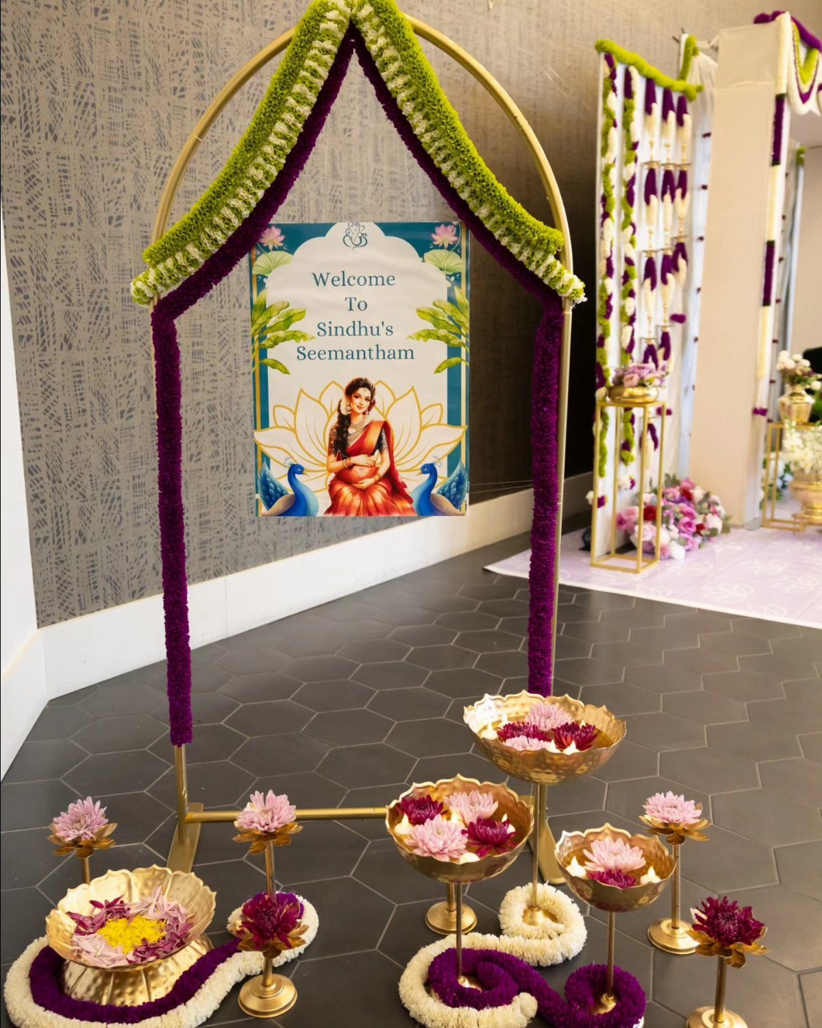 15 Seemantham Decoration Ideas for a Joyful Baby Shower 9 Welcome sign for Seemantham ceremony under a floral gold arch with decorative flower bowls.