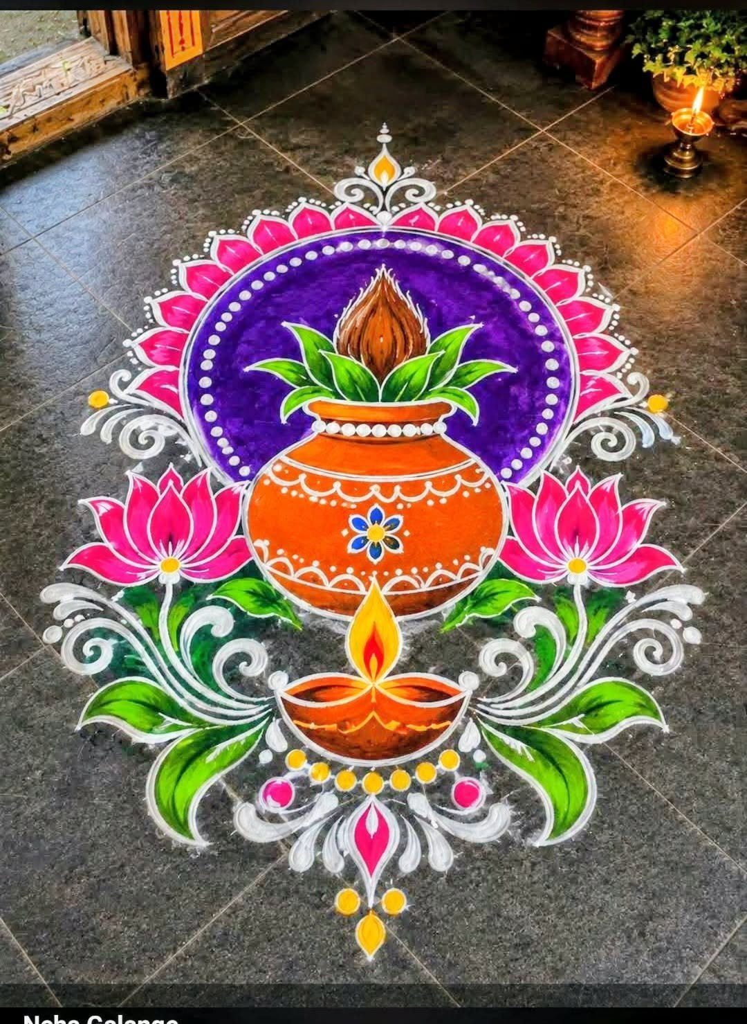 15 Seemantham Decoration Ideas for a Joyful Baby Shower 10 Colorful rangoli design on a dark floor featuring a pot and lit diya lamp.