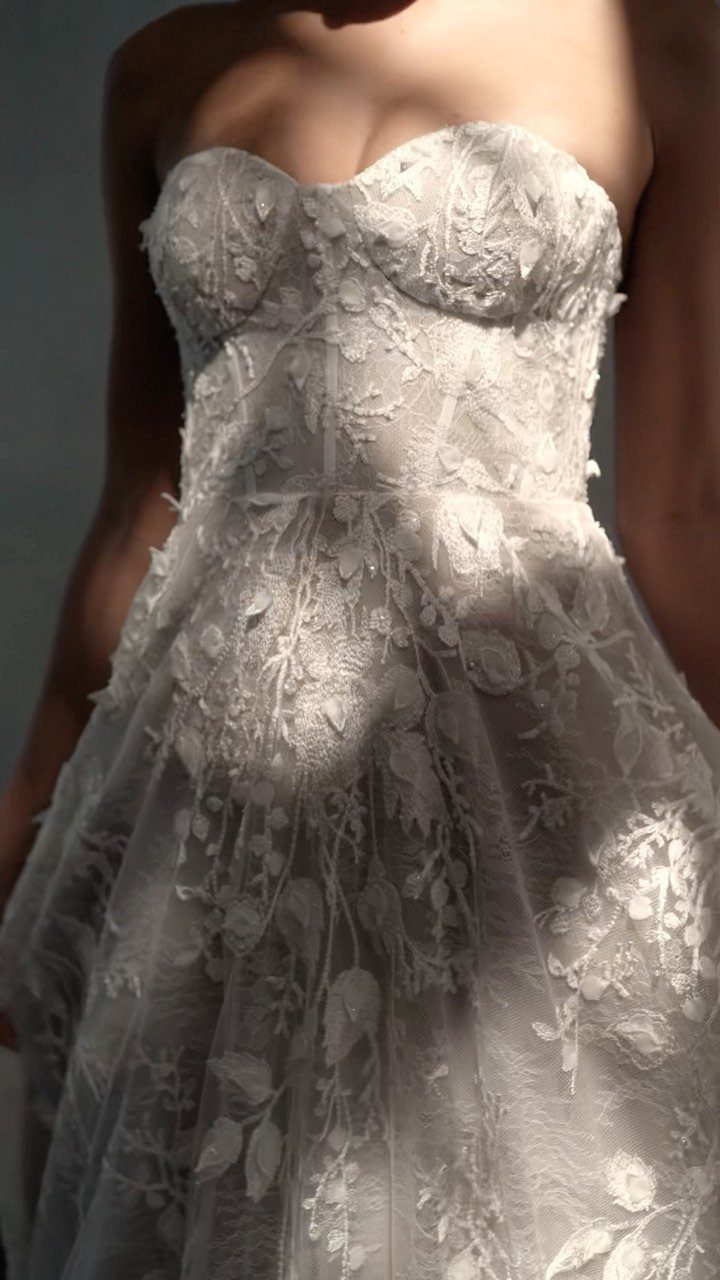 White strapless wedding dress with a sweetheart neckline and floral lace embroidery.