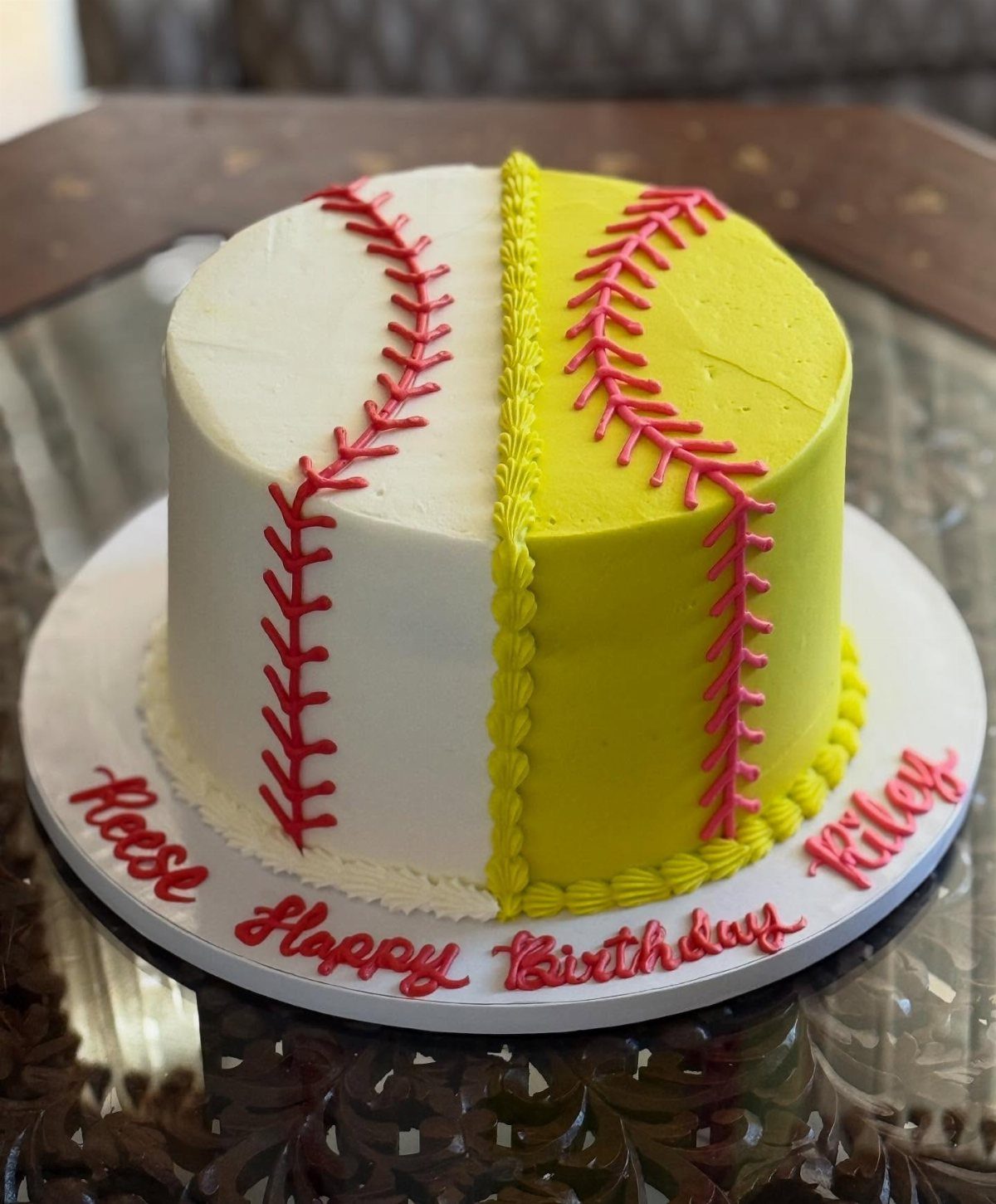 Split white and yellow baseball cake with red stitching and birthday greetings.