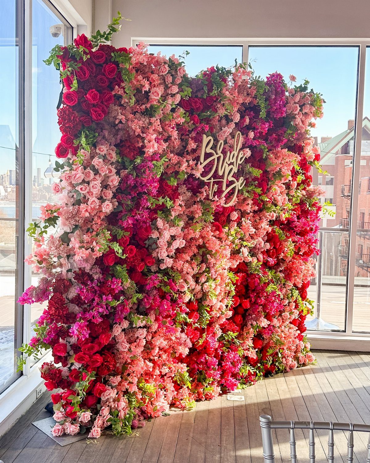 37 Wedding Cakes with Flowers to Inspire Your Design 22 Flower wall backdrop with pink and red blooms and a gold Bride to Be sign.