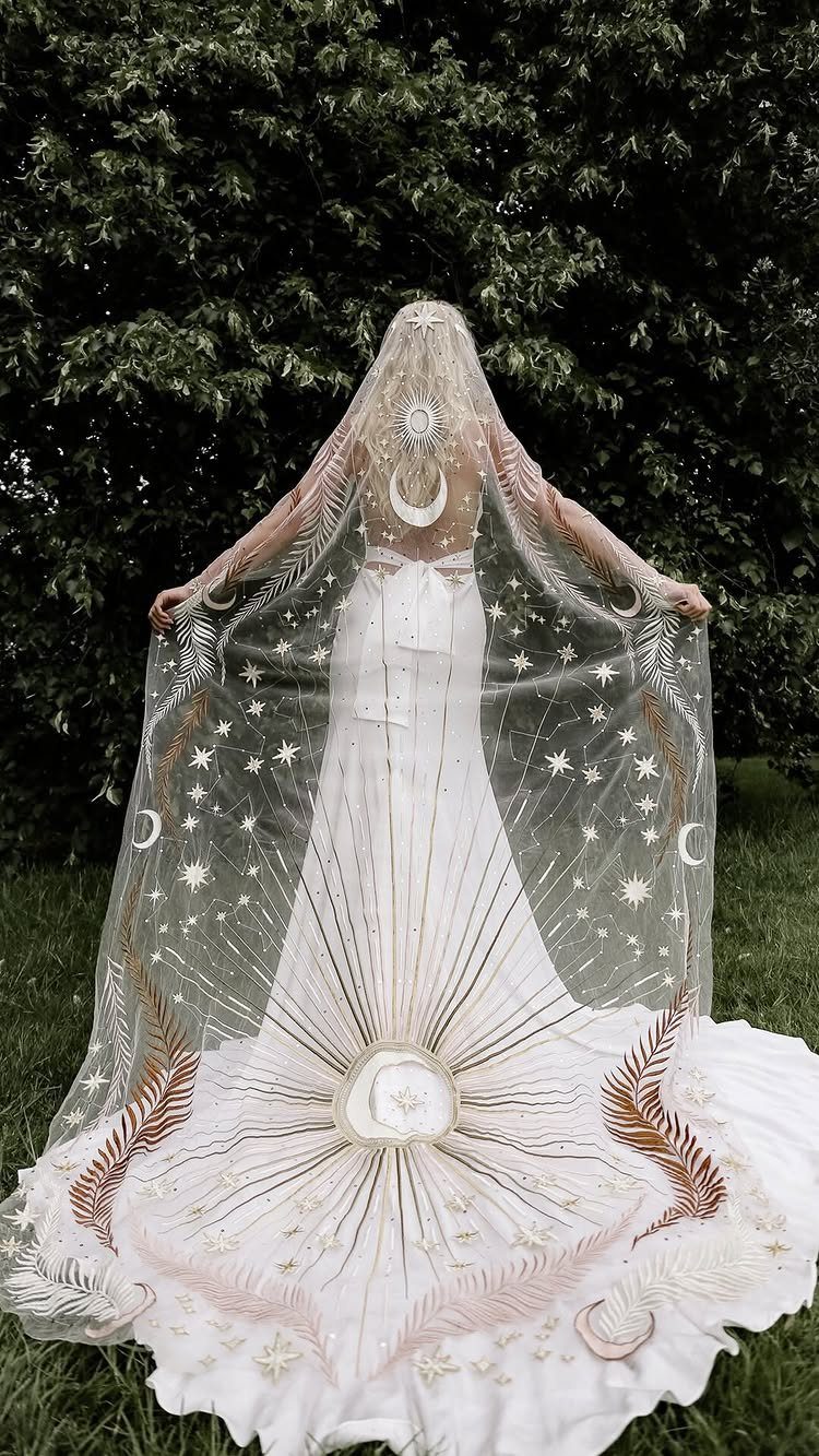 Wedding Mood Board Ideas: 39 Styles from Celestial to Coastal 13 Person in a white wedding dress with a celestial star and moon cape.