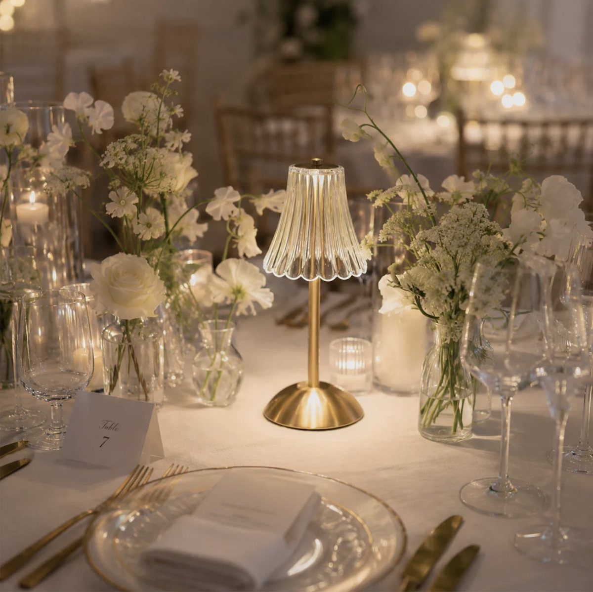 Wedding Mood Board Ideas: 39 Styles from Celestial to Coastal 10 Wedding table setting with white floral arrangements and a small gold table lamp.