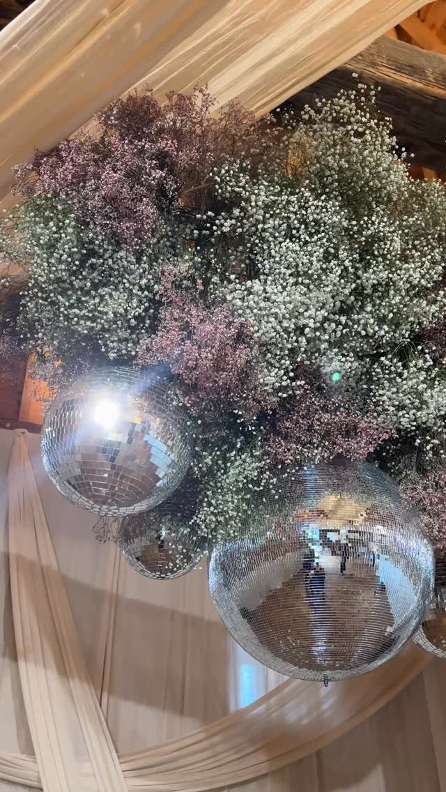 Wedding Mood Board Ideas: 39 Styles from Celestial to Coastal 5 Disco balls nestled within a large cloud of white and purple baby's breath flowers.