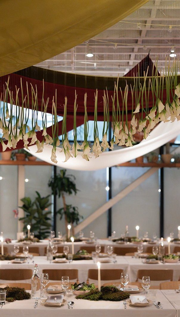 Wedding Mood Board Ideas: 39 Styles from Celestial to Coastal 4 White calla lilies hanging upside down from a ceiling over wedding reception tables.
