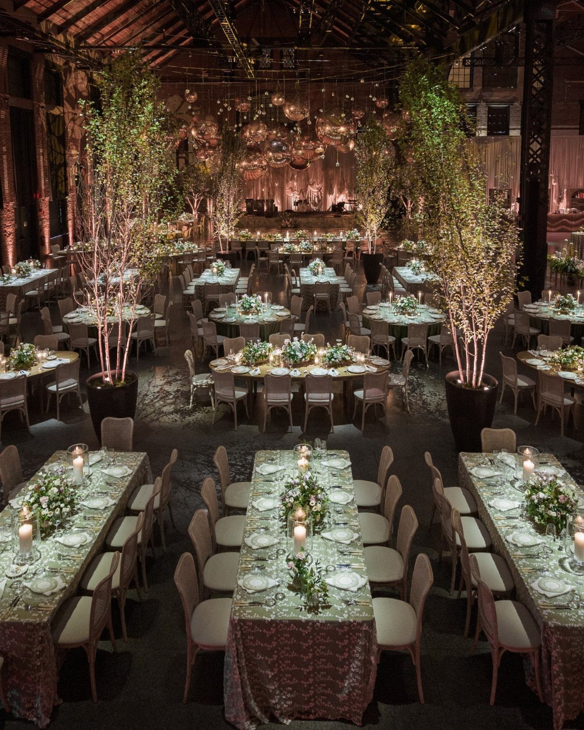 Wedding Mood Board Ideas: 39 Styles from Celestial to Coastal 7 Industrial warehouse venue decorated with elegant dinner tables and tall indoor trees.