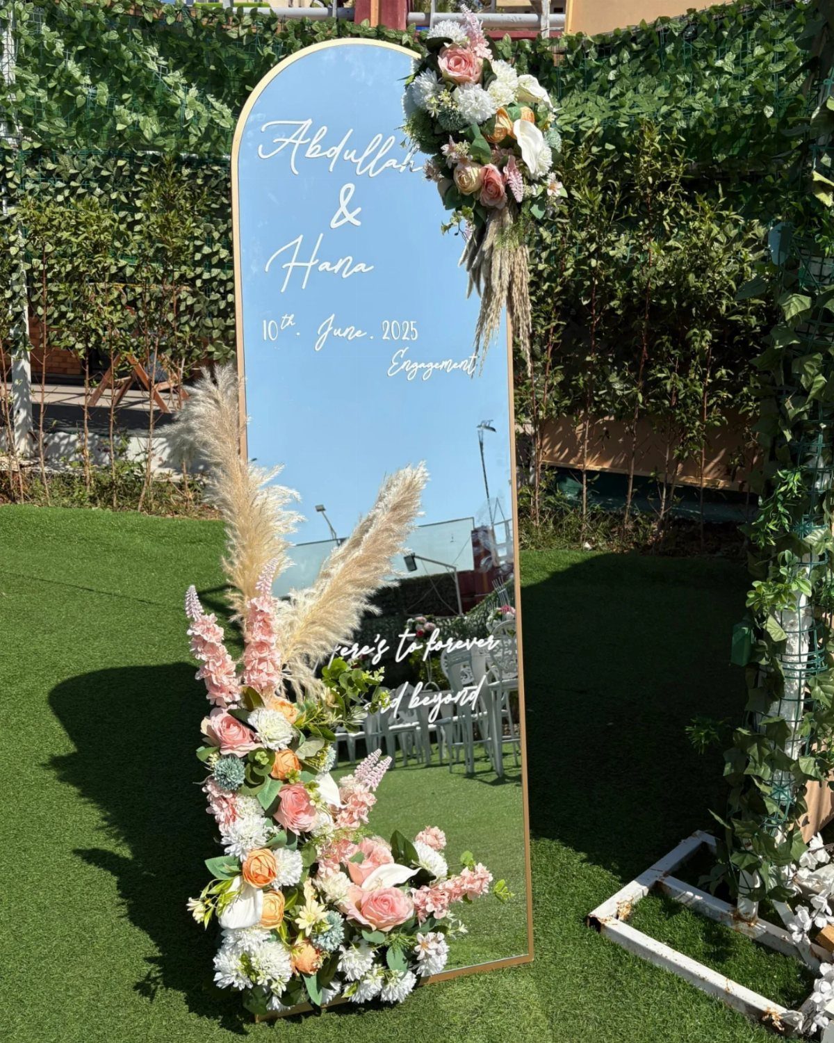 Wedding Mood Board Ideas: 39 Styles from Celestial to Coastal 26 Arched gold mirror decorated with peach and white roses on green grass.