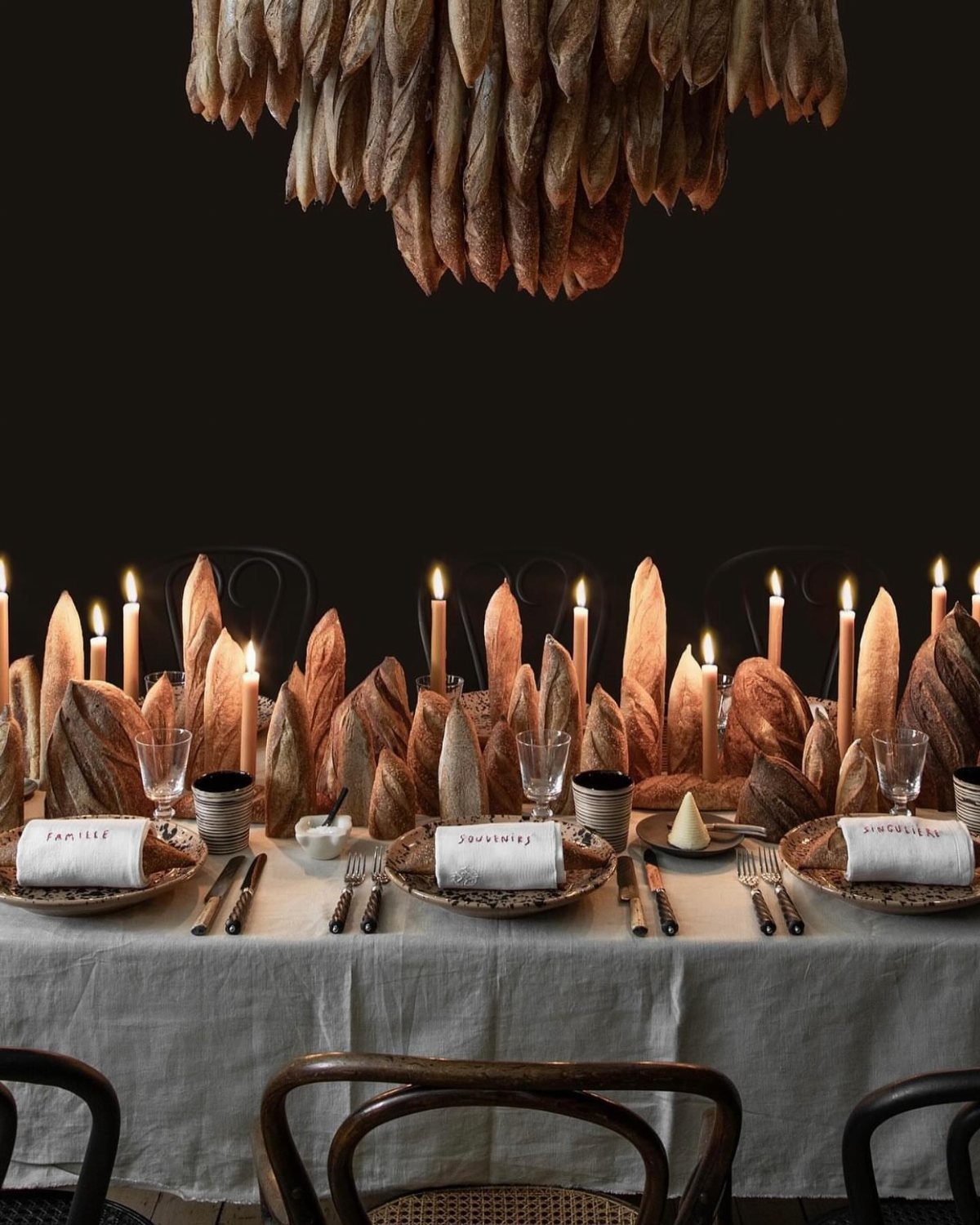 Wedding Mood Board Ideas: 39 Styles from Celestial to Coastal 28 Dining table centerpiece featuring numerous sourdough bread loaves and tall lit candles.