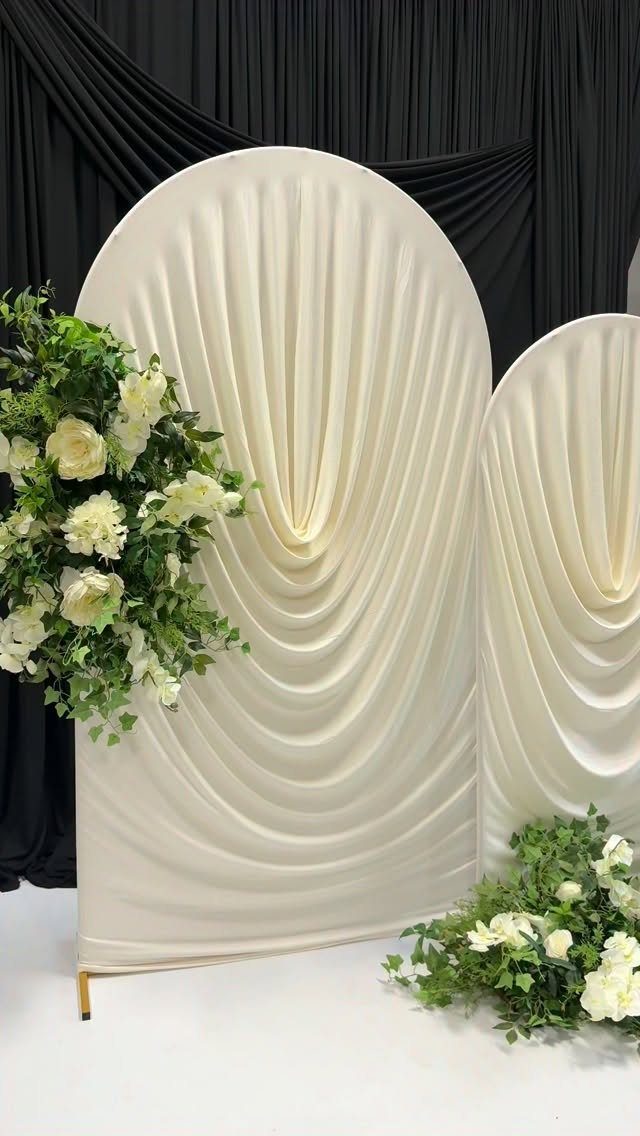 Wedding Mood Board Ideas: 39 Styles from Celestial to Coastal 37 Cream draped fabric arched backdrops decorated with white roses and green foliage.