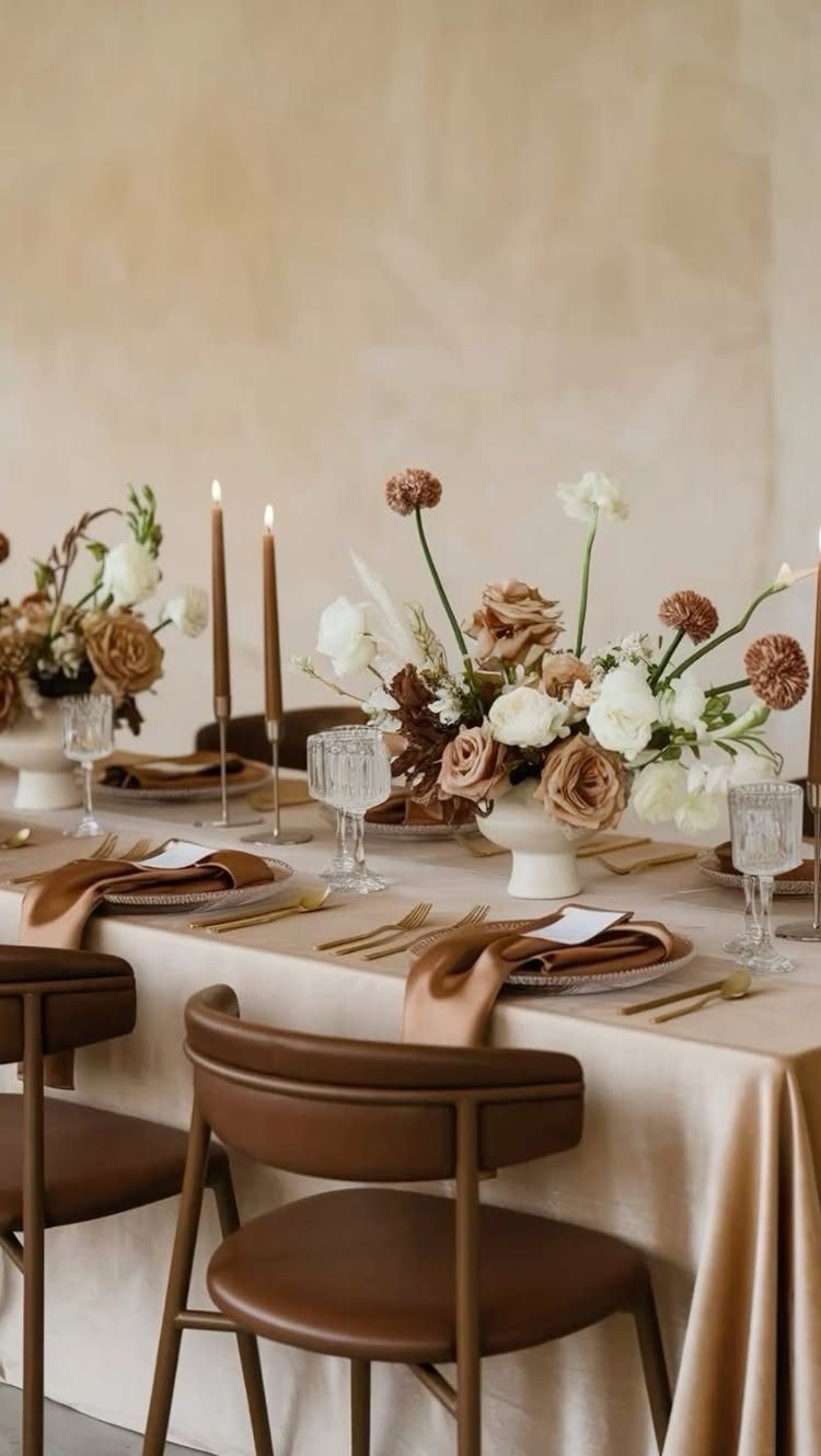 Elegant wedding table setting with beige and brown theme colors and floral centerpieces.